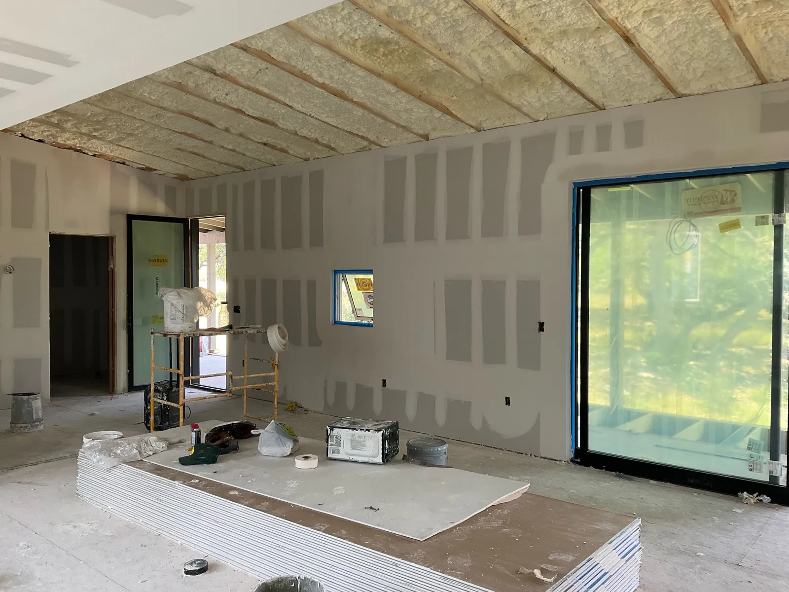Interior rooms with finished drywall installation, ready for painting and finishing